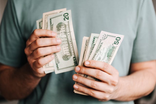 Person counting money with both hands